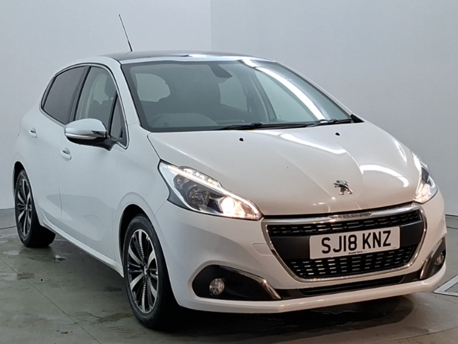 White Peugeot 208 front three-quarter view